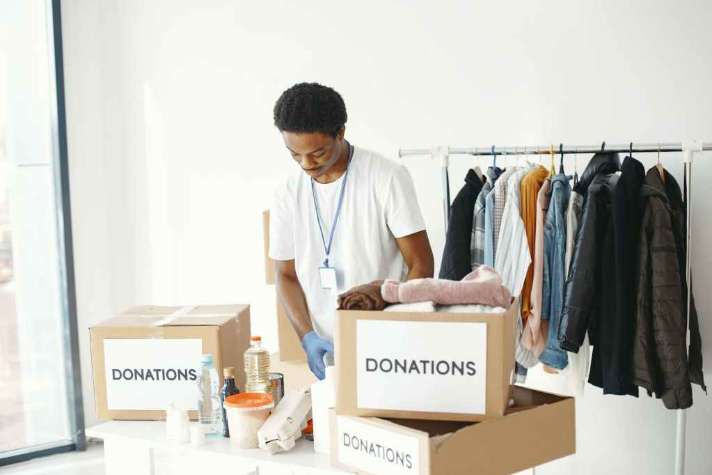 male volunteer packing up donations